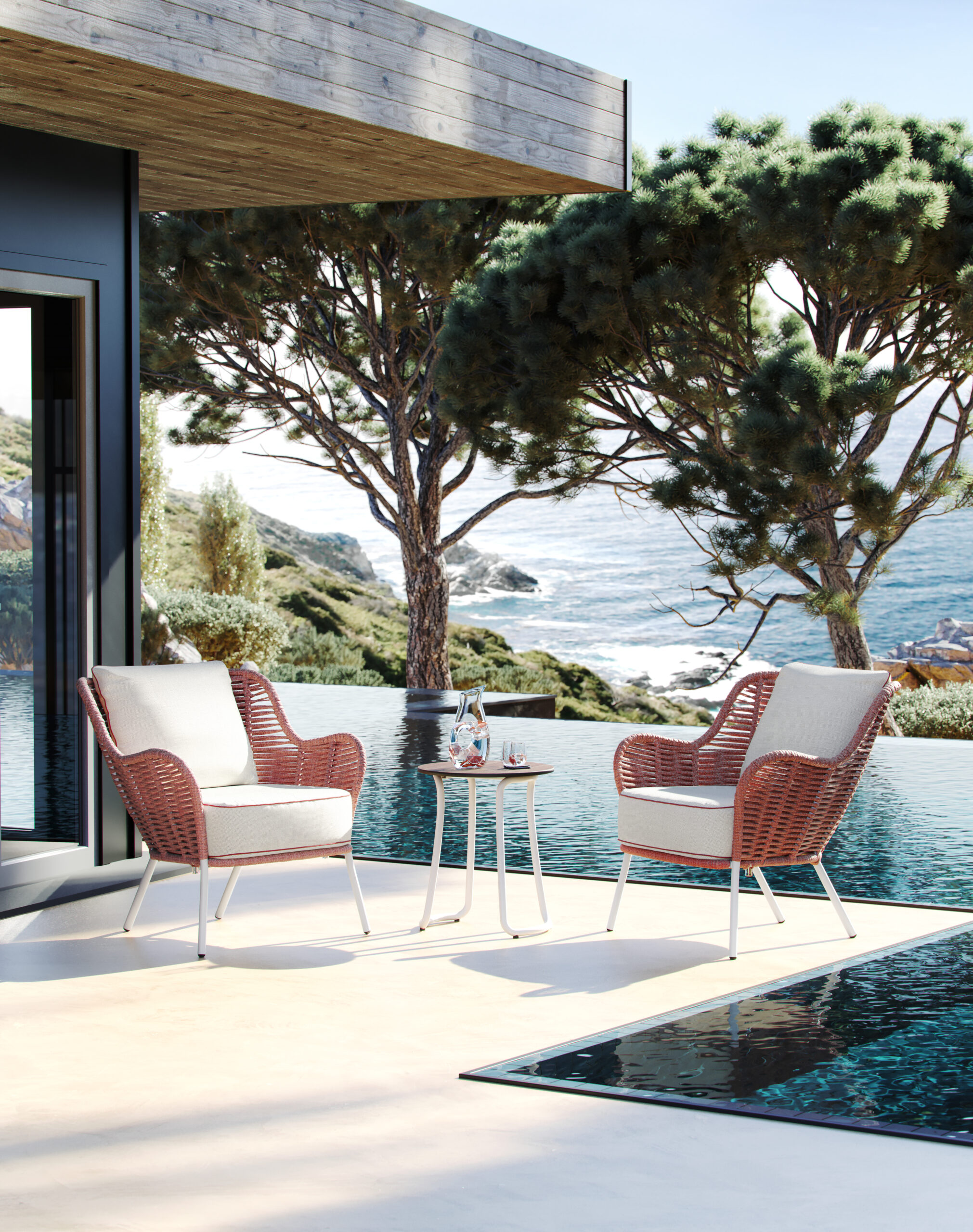 Malti Strap sofa and lounge chairs set out on a paved terrace