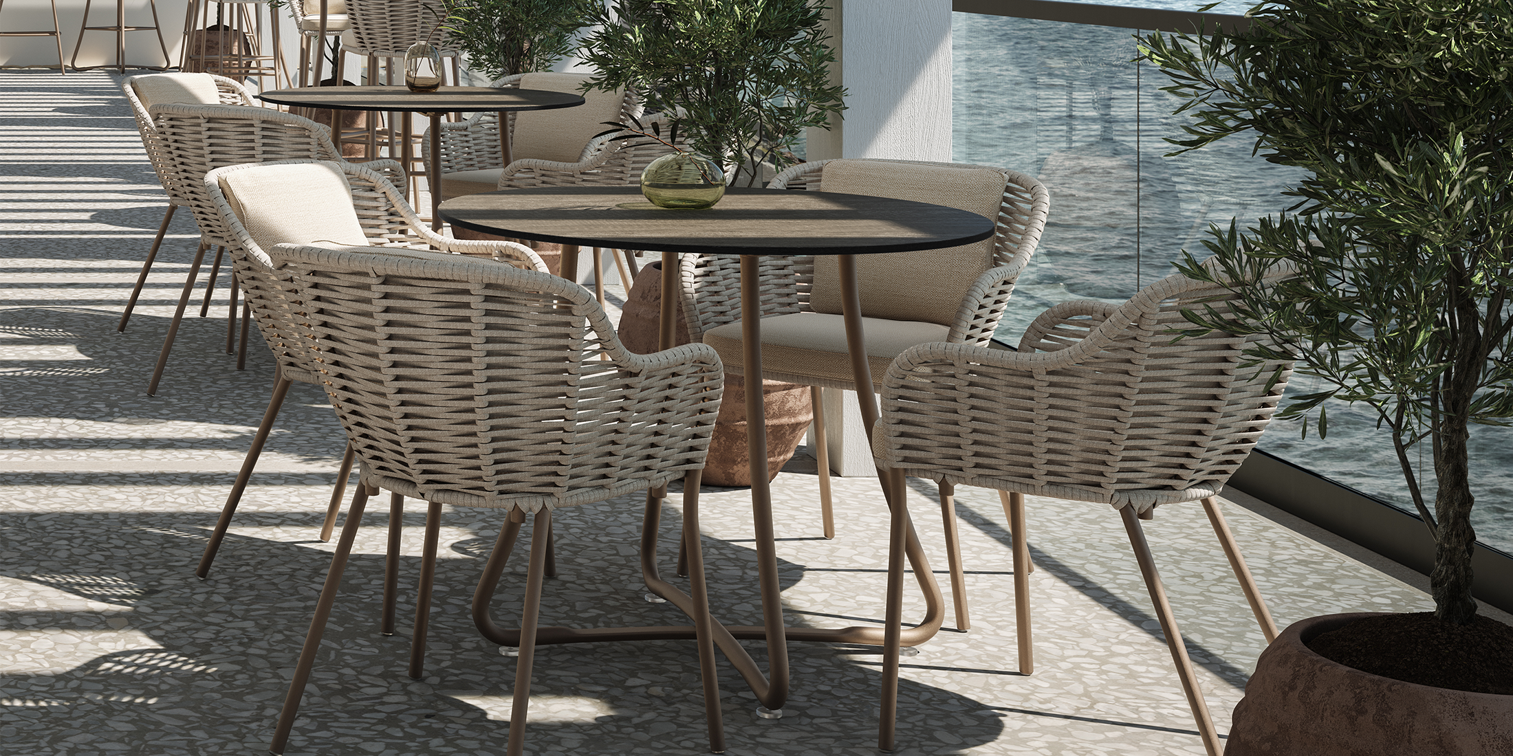 Malti Strap dining chairs drawn up to an outdoor dining table